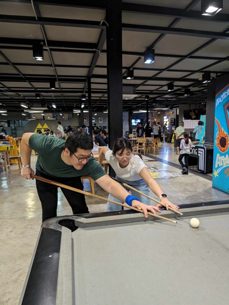 Yod and Lhing playing pool at Gamesmith