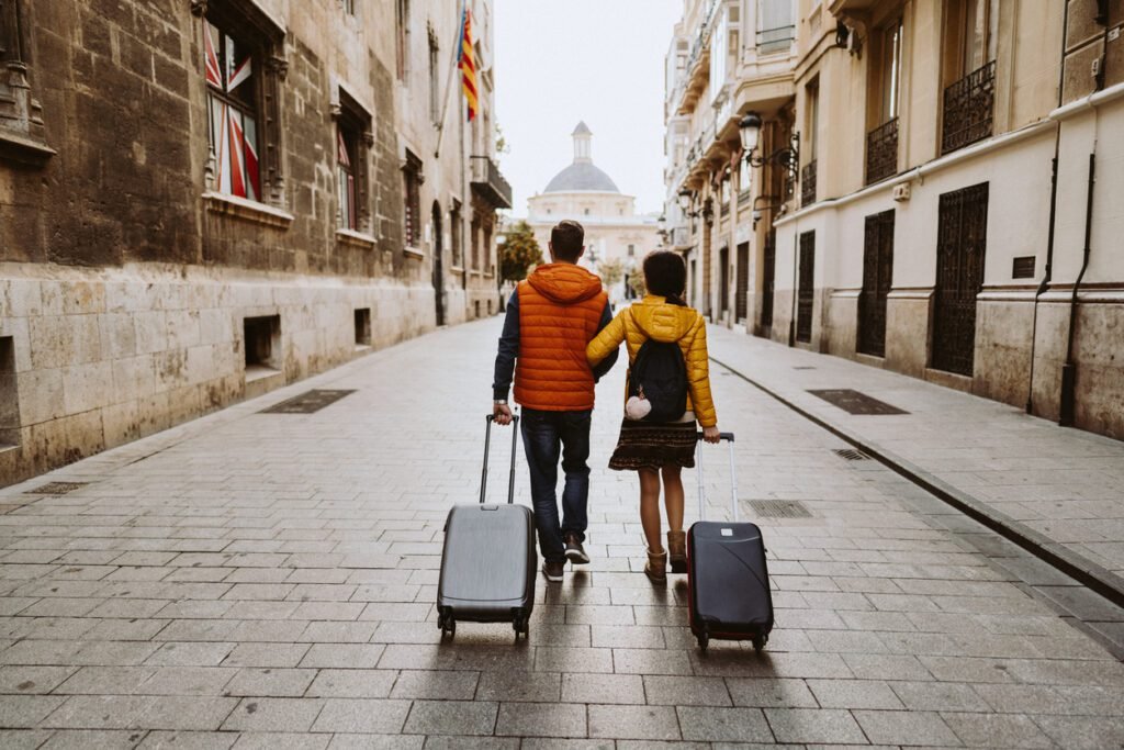 Rear view of couple arriving in Valencia early in the morning