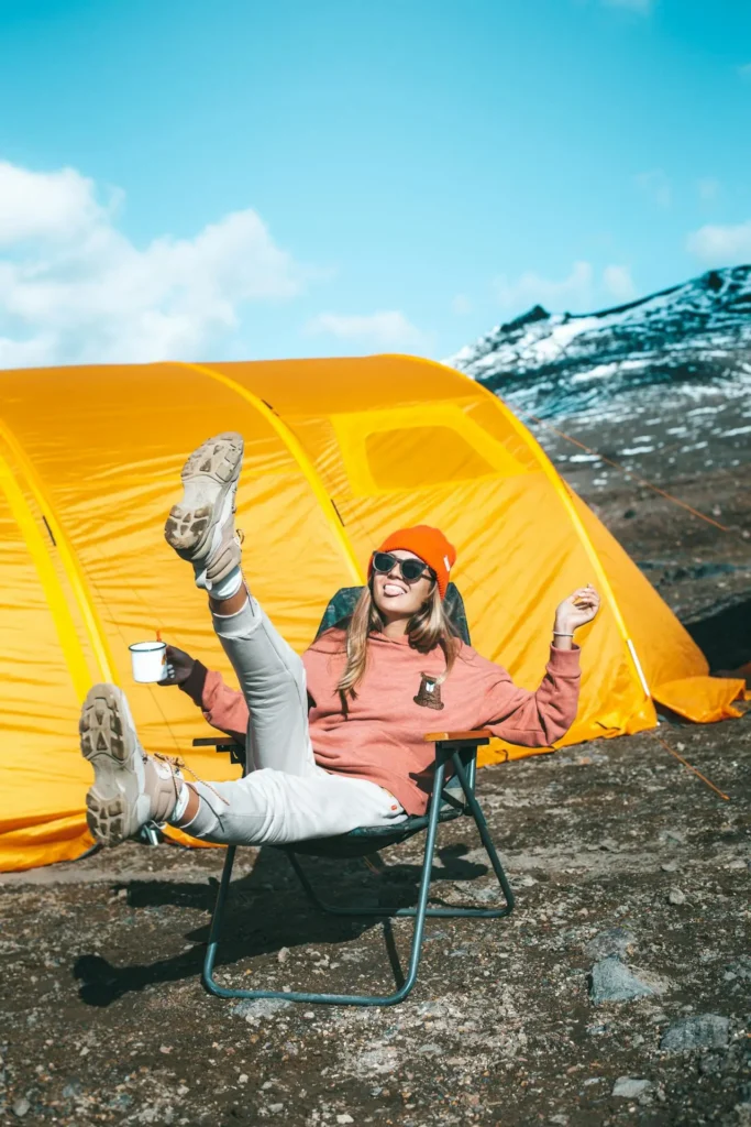 A happy girl camping by the mountains